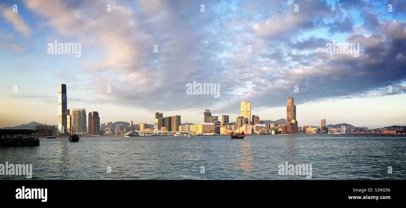 Panorama of West Kowloon, Tsim Sha Tsui, Hung Hom, viewed across Victoria Harbour from Tamar Park, Admiralty, Central, Hong Kong Island, late afternoon - Smartphone Captured Stock Image