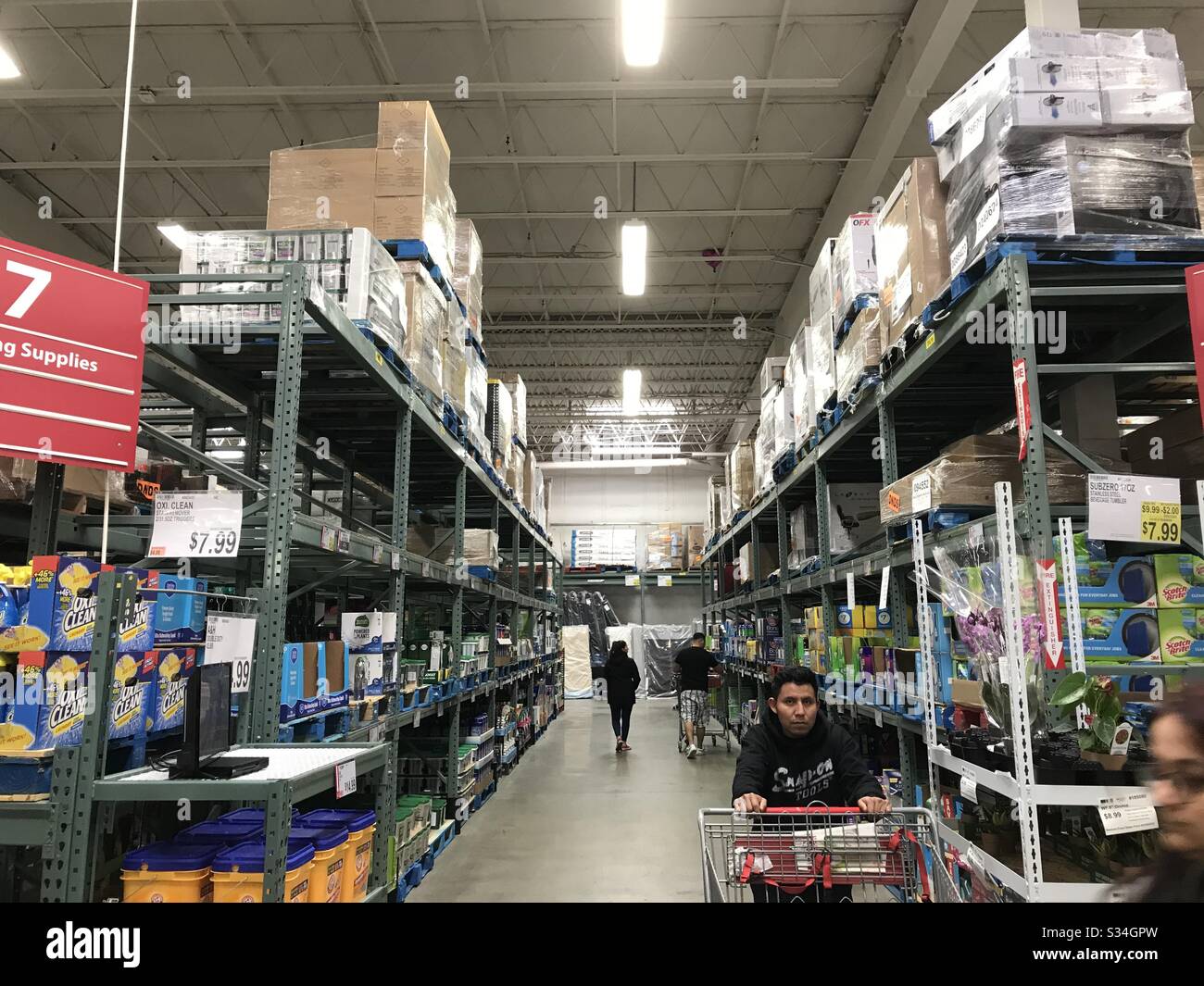 People stocking up in an half empty cleaning supplies aisle in club supermarket mid of March 2020 in New Jersey USA - Smartphone Captured Stock Image