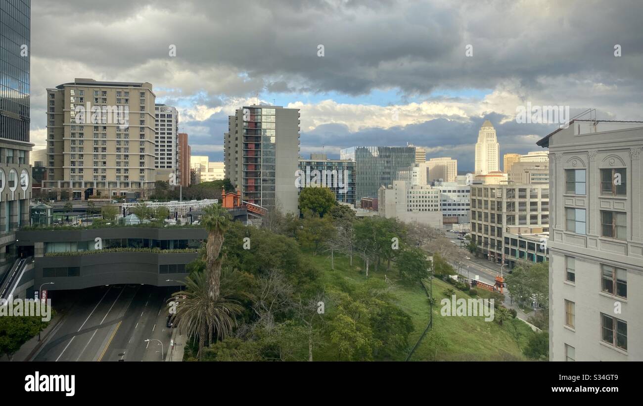 LOS ANGELES, CA, MAR 2020: Downtown, view across Bunker Hill towards Civic Center, with California Plaza skyscraper, offices and apartments on left of frame. Overcast with sunlight catching City Hall - Smartphone Captured Stock Image