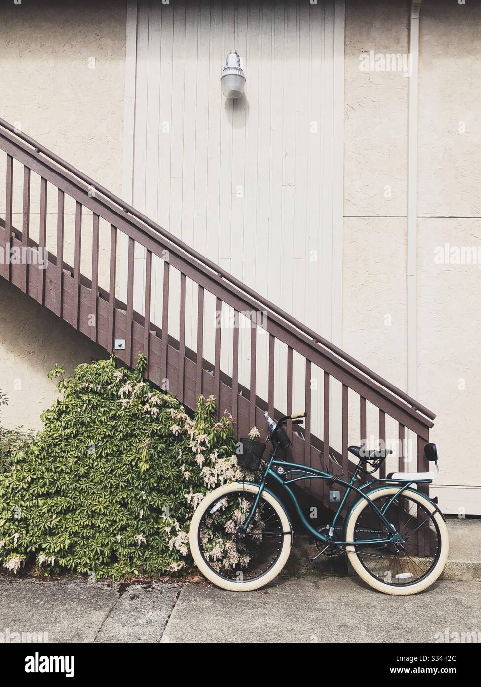 Parked vintage bicycle near stairway at old apartment complex in Issaquah, WA - Smartphone Captured Stock Image