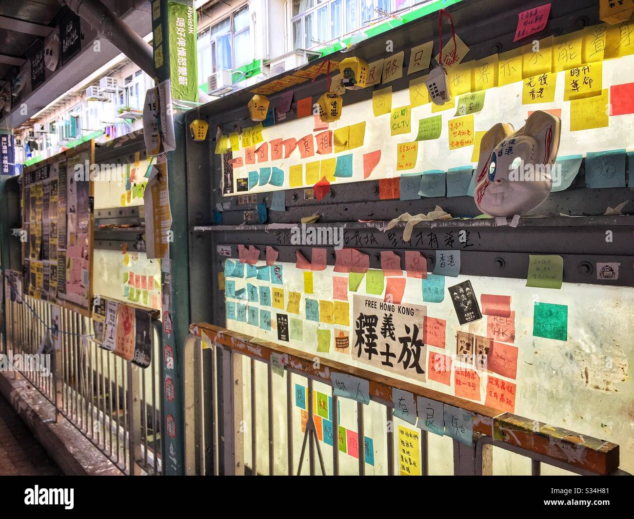 Sticky notes and other signs left by protesters on an elevated pedestrian bridge in Mong Kok, Kowloon, Hong Kong, October 2019 - Smartphone Captured Stock Image