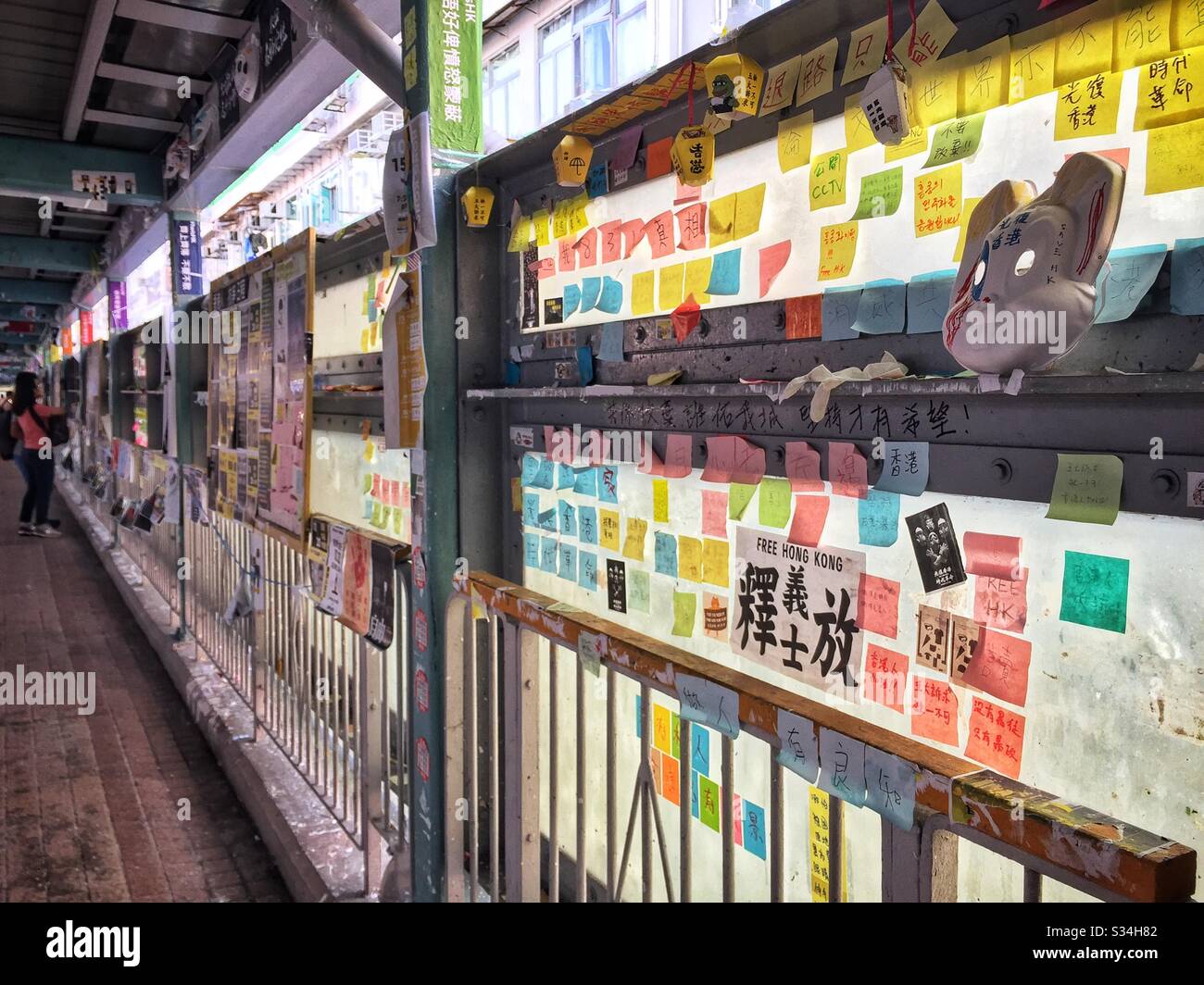 Sticky notes and other signs left by protesters on an elevated pedestrian bridge in Mong Kok, Kowloon, Hong Kong, October 2019 - Smartphone Captured Stock Image