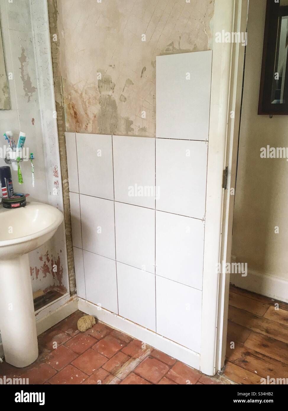 Bathroom tiles being mounted on the wall. - Smartphone Captured Stock Image