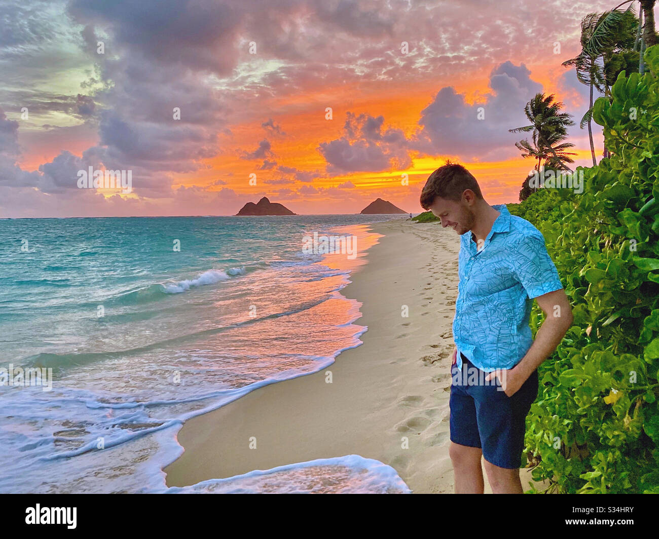Man watching sunrise in Hawaii Stock Photo