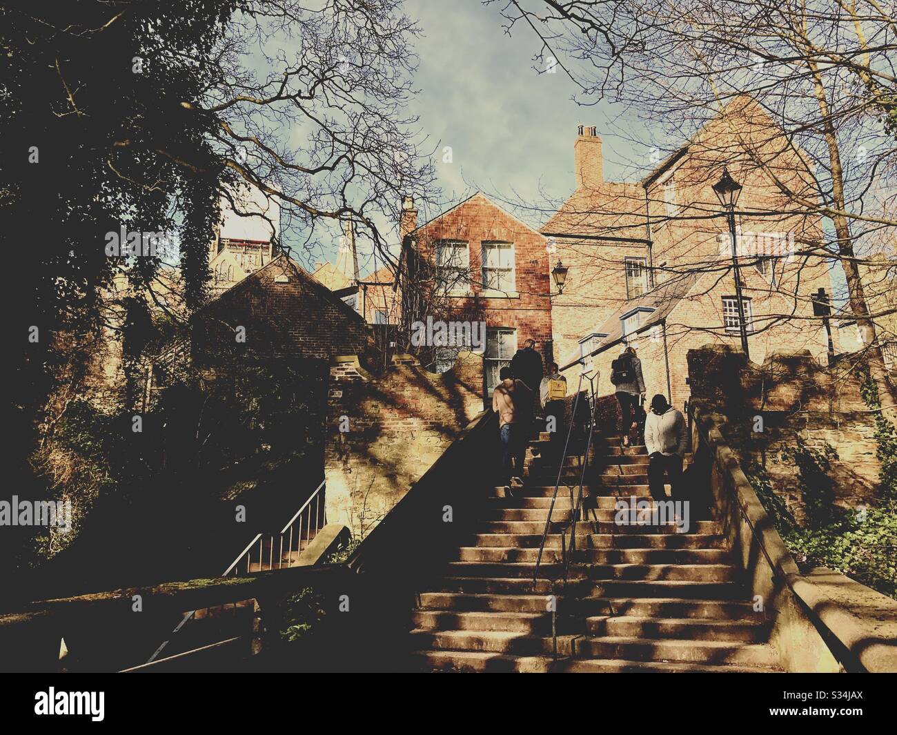 Architecture of Durham City, North East England. People use steps leading to Bow Lane from Kingsgate Bridge - Smartphone Captured Stock Image