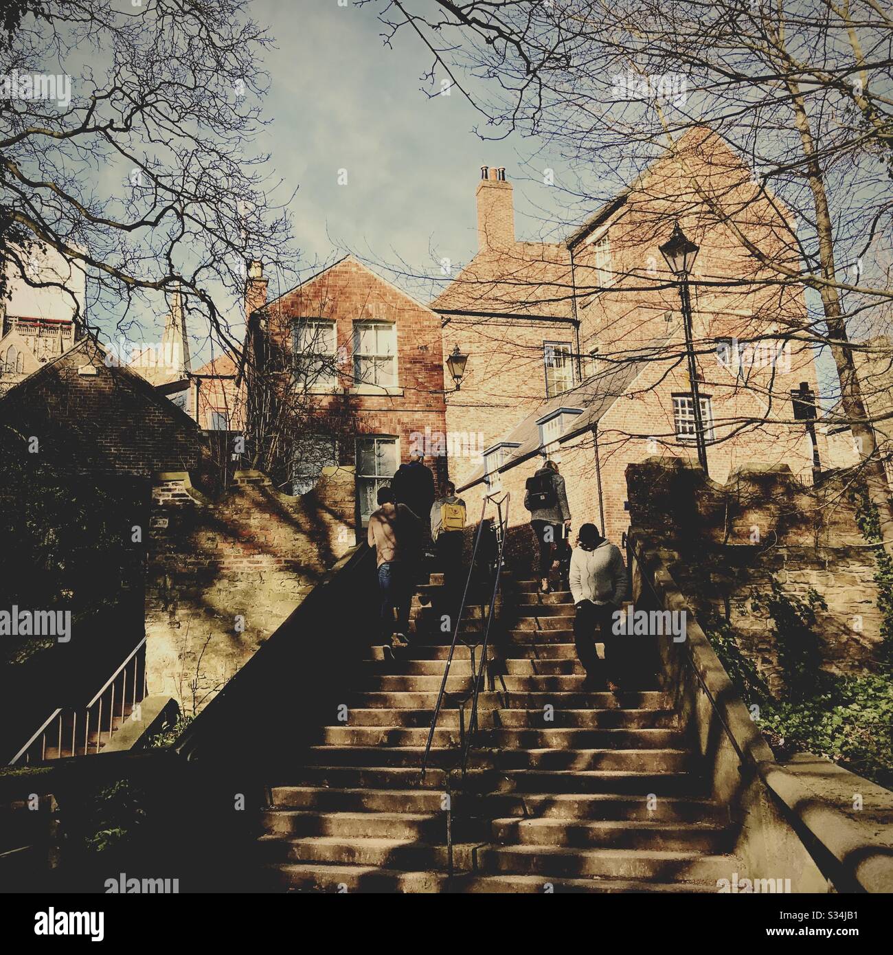 Architecture of Durham City, North East England. Pedestrians using steps leading to Bow Lane from Kingsgate Footbridge - Smartphone Captured Stock Image
