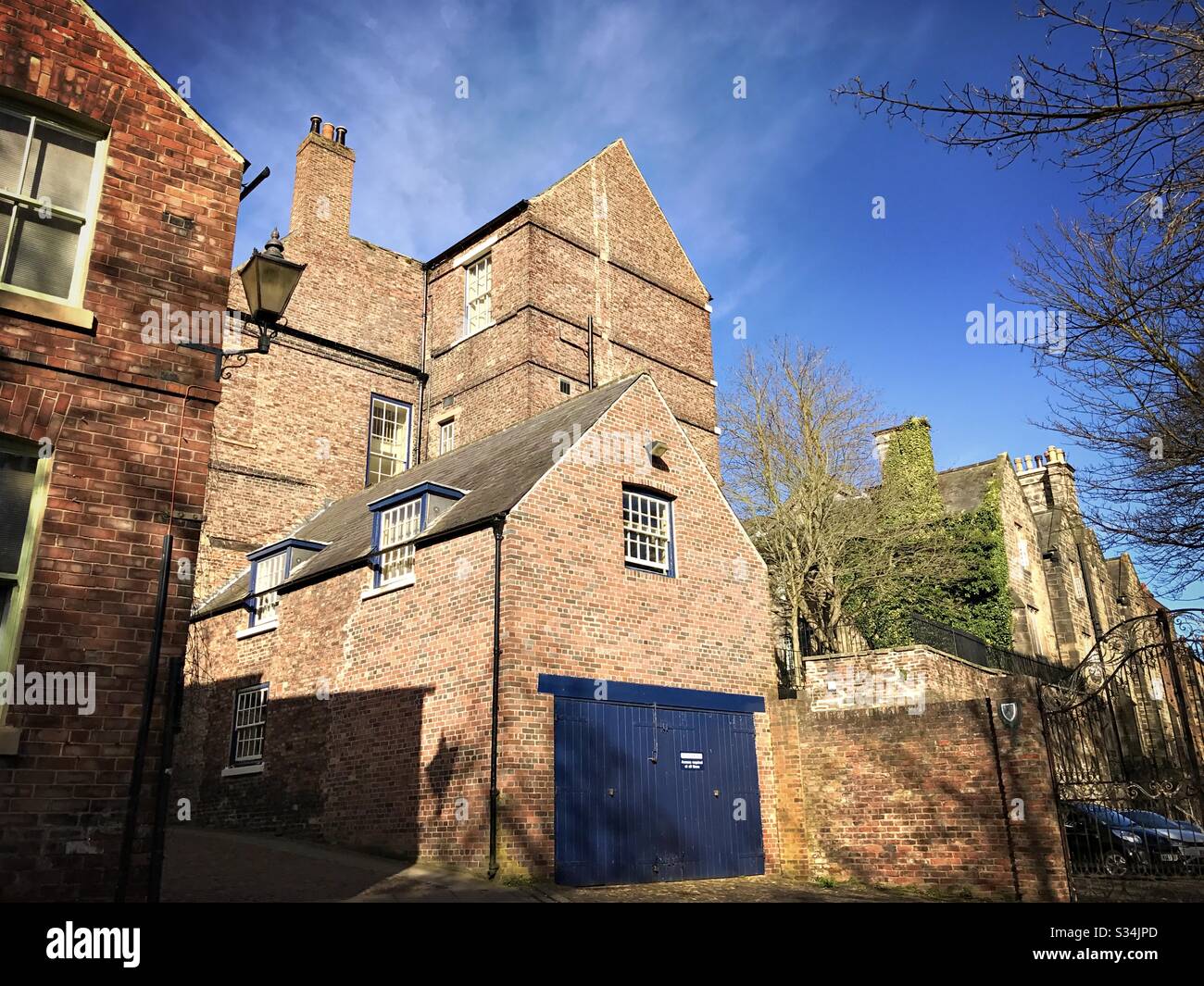 Architecture of Durham City, North East England. Quaint backstreet scene. Red brick buildings of Bow Lane - Smartphone Captured Stock Image