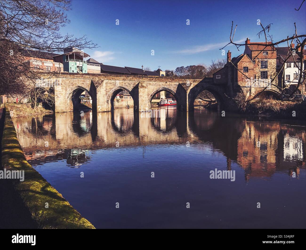 Architecture of Durham City, North East England. Scenic view of Elvet Bridge over the River Wear. Medieval masonry arch bridge. - Smartphone Captured Stock Image
