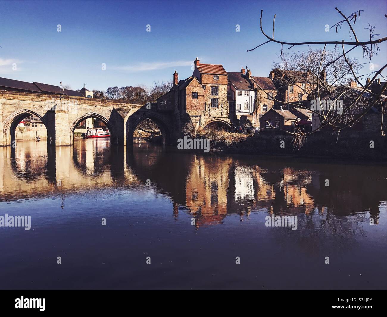 Architecture of Durham City, North East England. Scenic view of Elvet Bridge over the River Wear. Medieval masonry arch bridge. - Smartphone Captured Stock Image