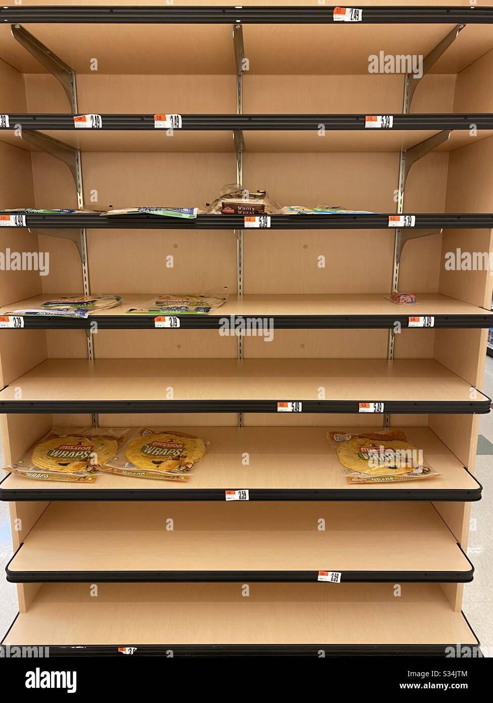 Grocery stores are experiencing shortages due to customers panic buying and hoarding during the COVID-19 pandemic crisis. - Smartphone Captured Stock Image