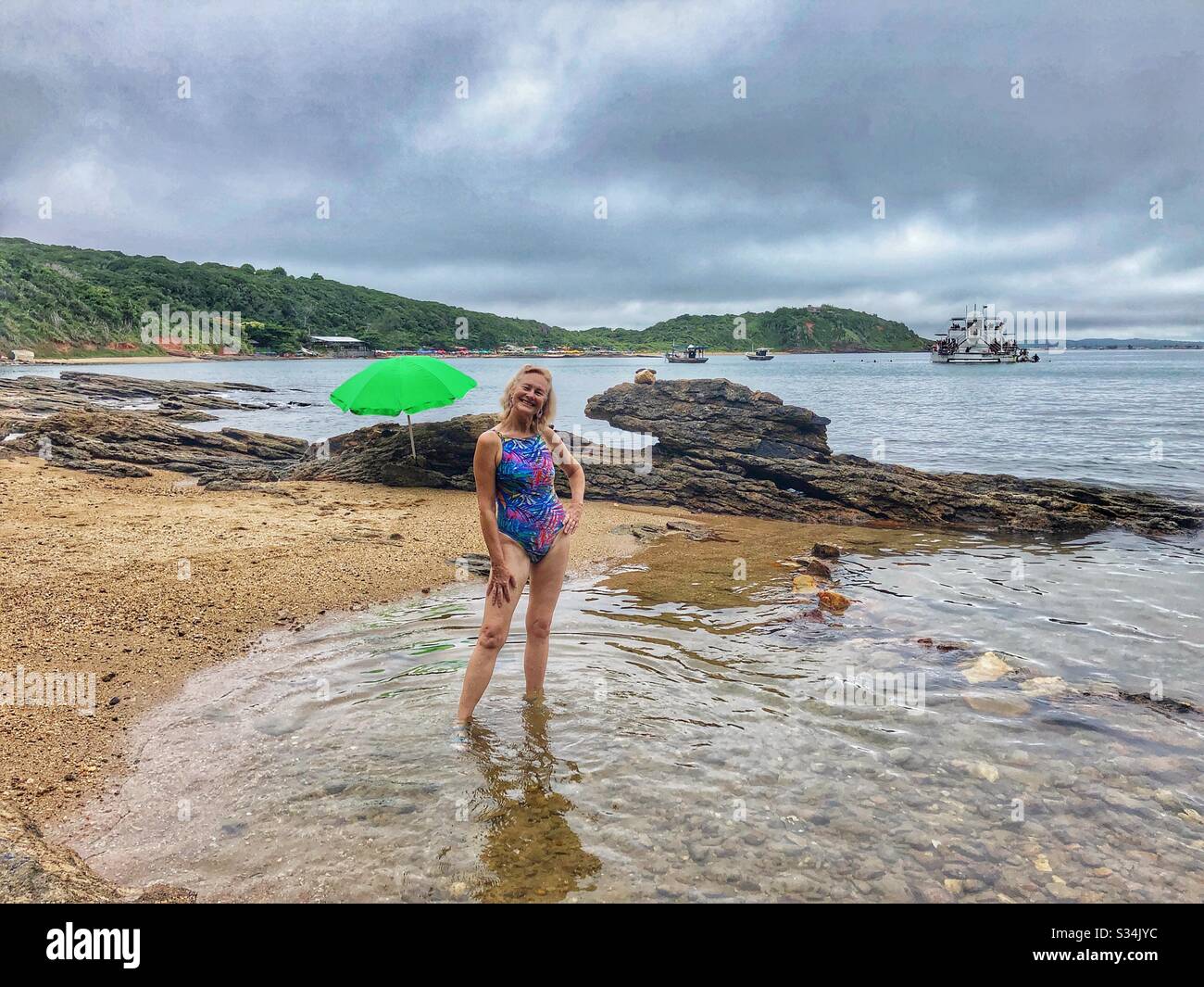 Enjoying an empty beach on an overcast day. Stock Photo