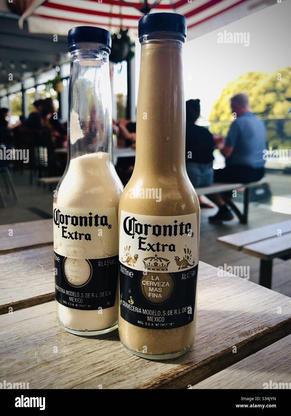 Corona beer bottles being used as salt and pepper pots Stock Photo