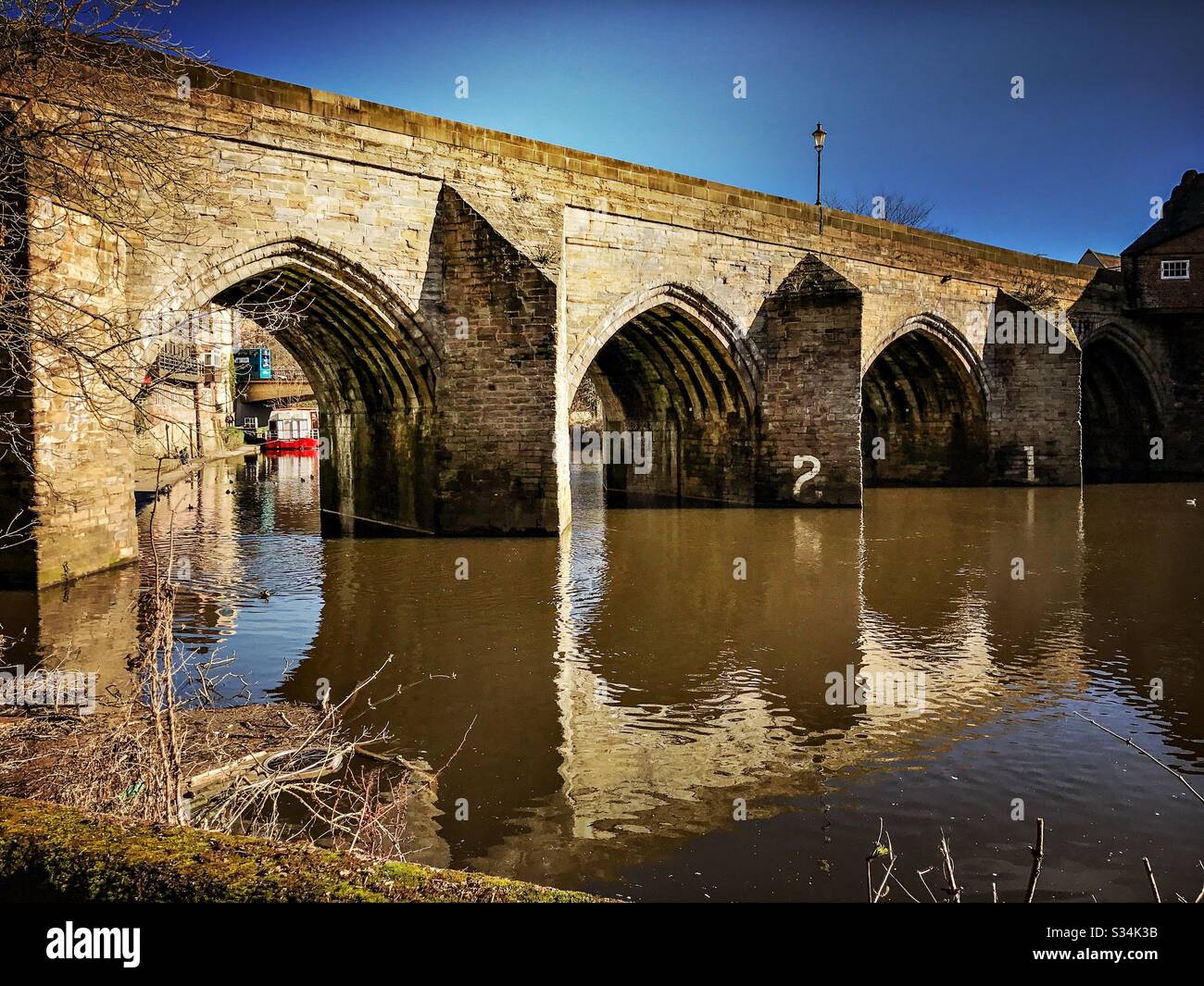 Architecture of Durham City, North East England. Scenic view of Elvet Bridge over the River Wear. Medieval masonry arch bridge. - Smartphone Captured Stock Image