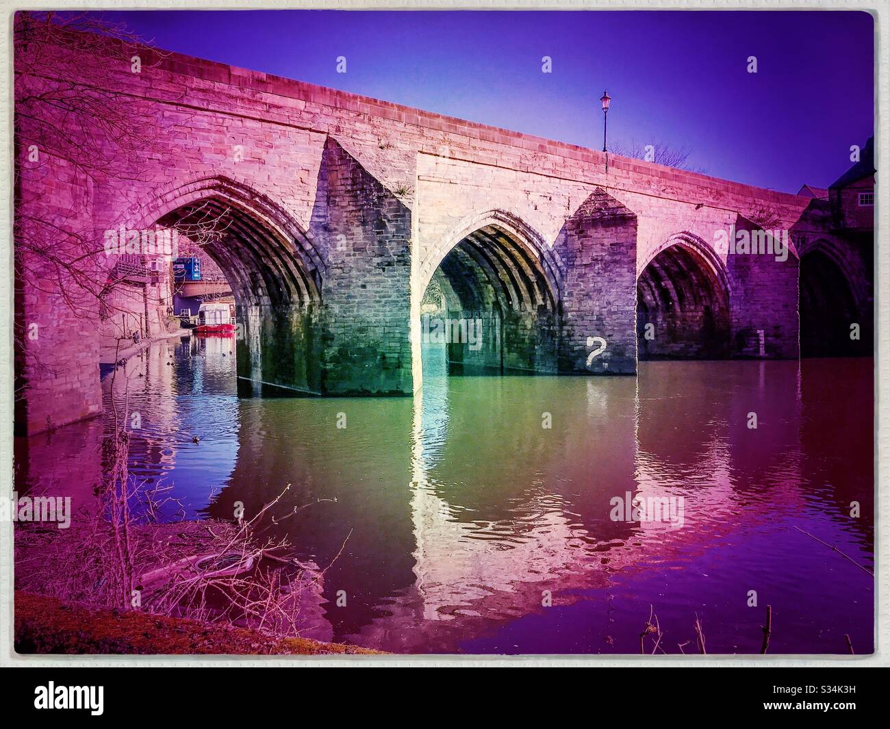 Architecture of Durham City, North East England. Scenic view of Elvet Bridge over the River Wear. Medieval masonry arch bridge. - Smartphone Captured Stock Image