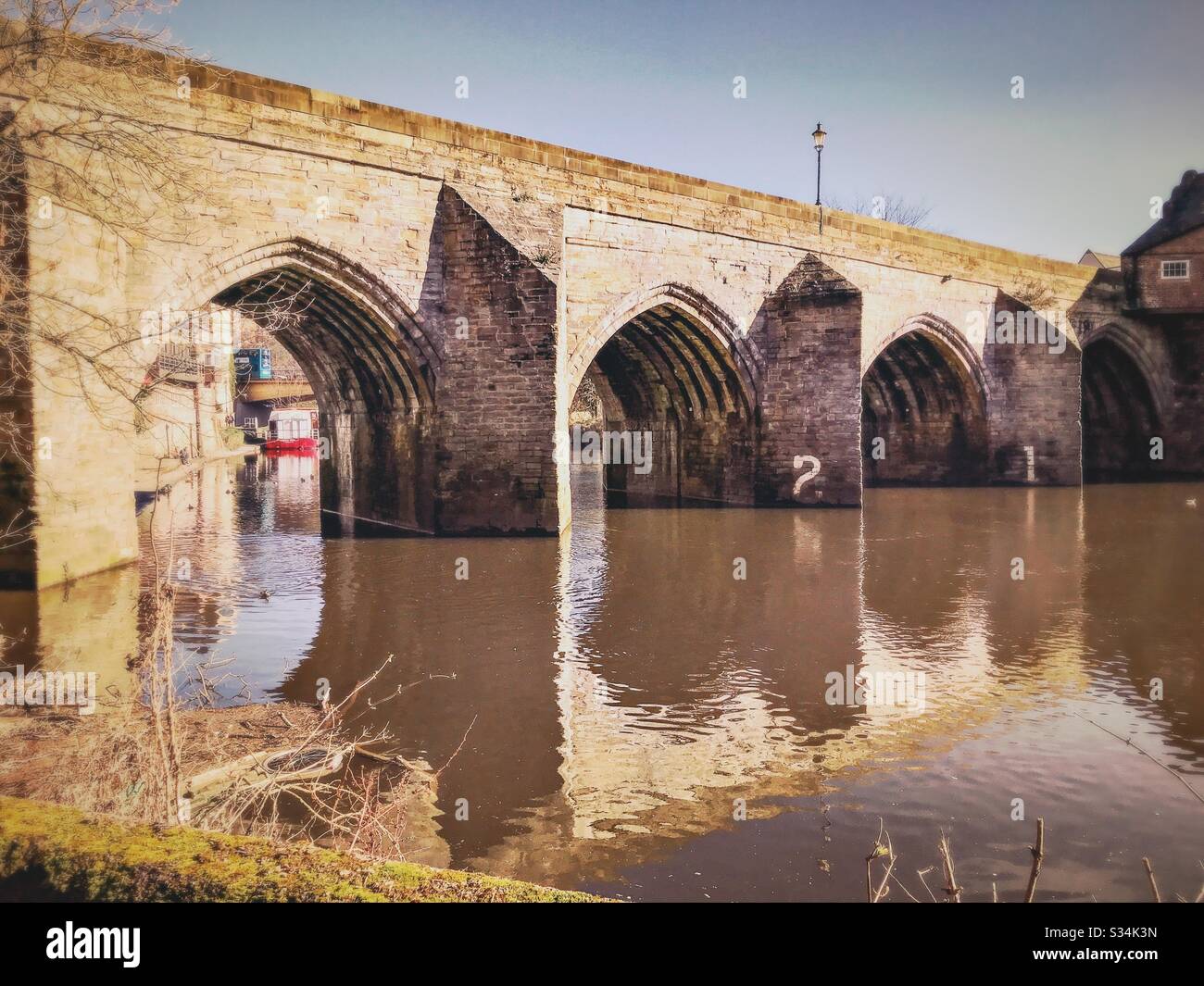 Architecture of Durham City, North East England. Scenic view of Elvet Bridge over the River Wear. Medieval masonry arch bridge. - Smartphone Captured Stock Image