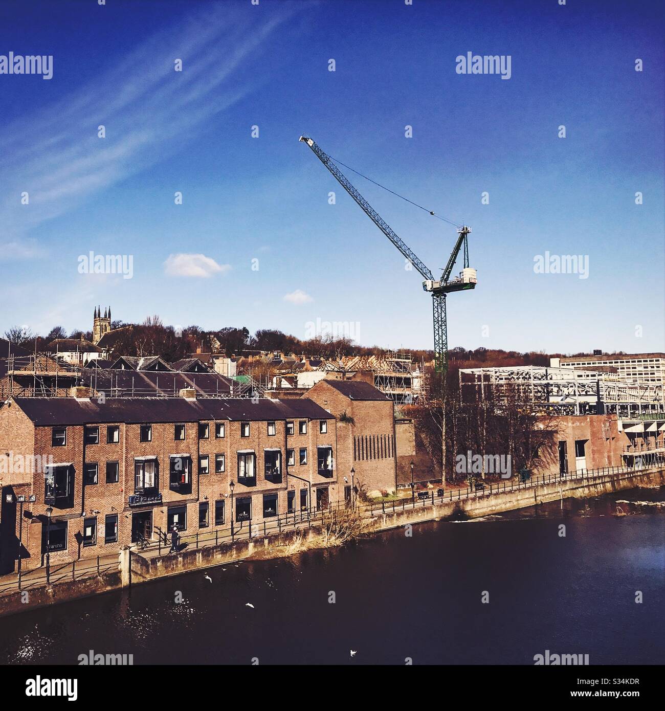 Architecture of Durham City, North East England. Skyline of the city centre by the Rover Wear with tall crane during development and construction work - Smartphone Captured Stock Image