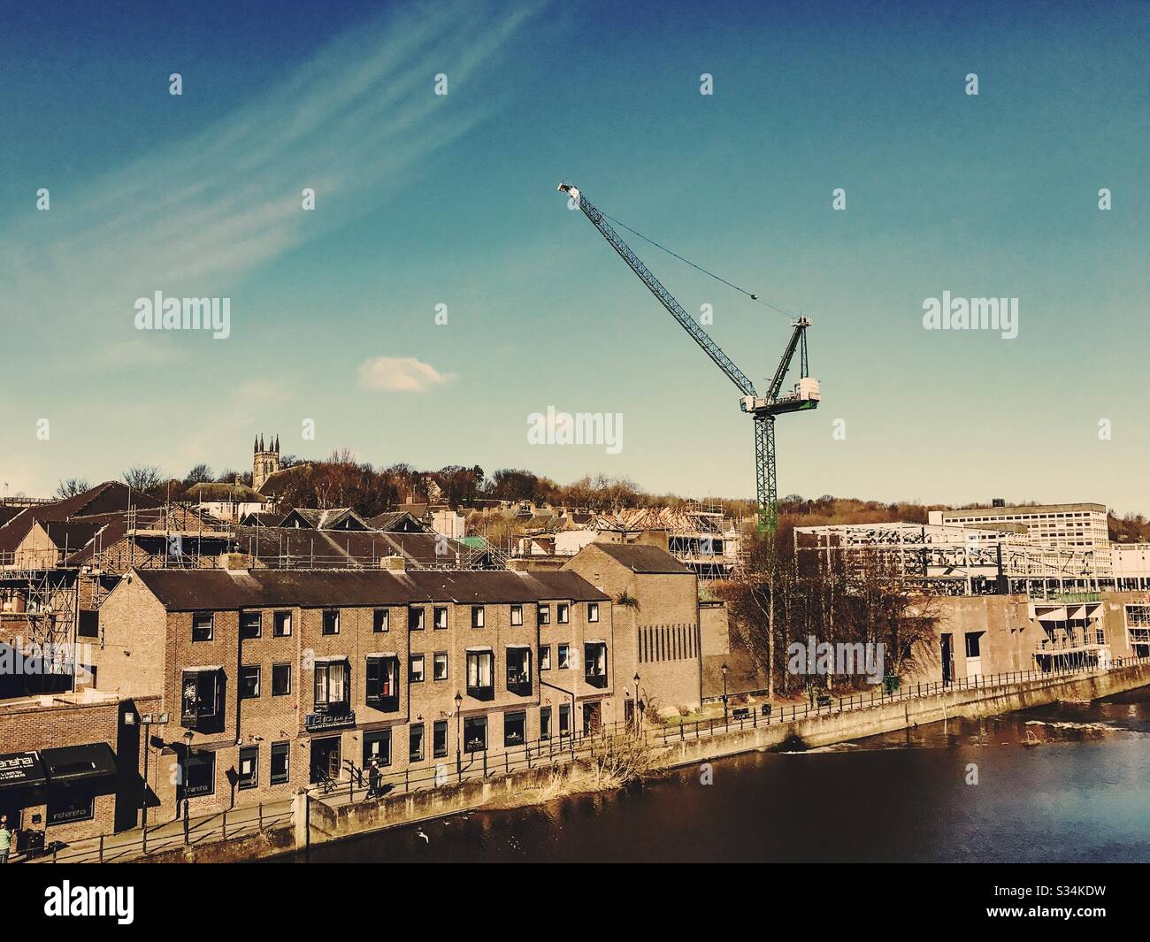 Architecture of Durham City, North East England. Skyline of the city centre by the Rover Wear with tall crane during development and construction work - Smartphone Captured Stock Image