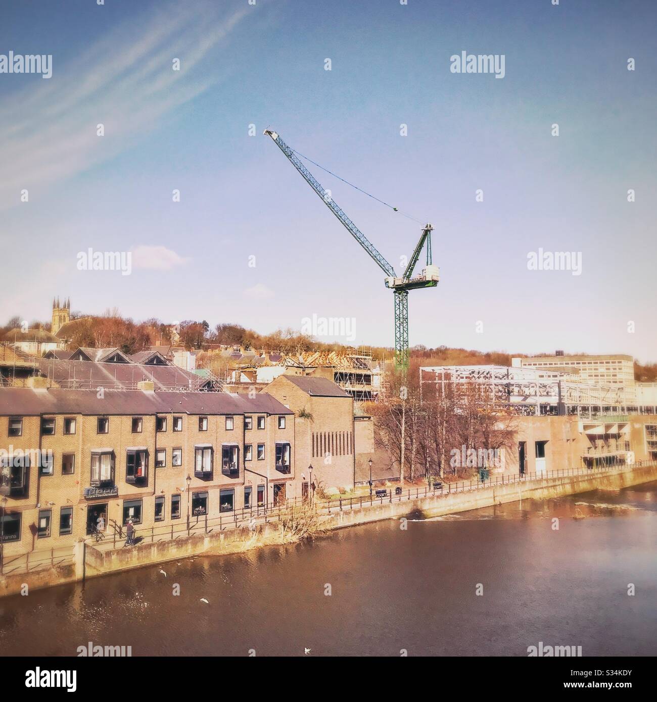 Architecture of Durham City, North East England. Skyline of the city centre by the Rover Wear with tall crane during development and construction work - Smartphone Captured Stock Image