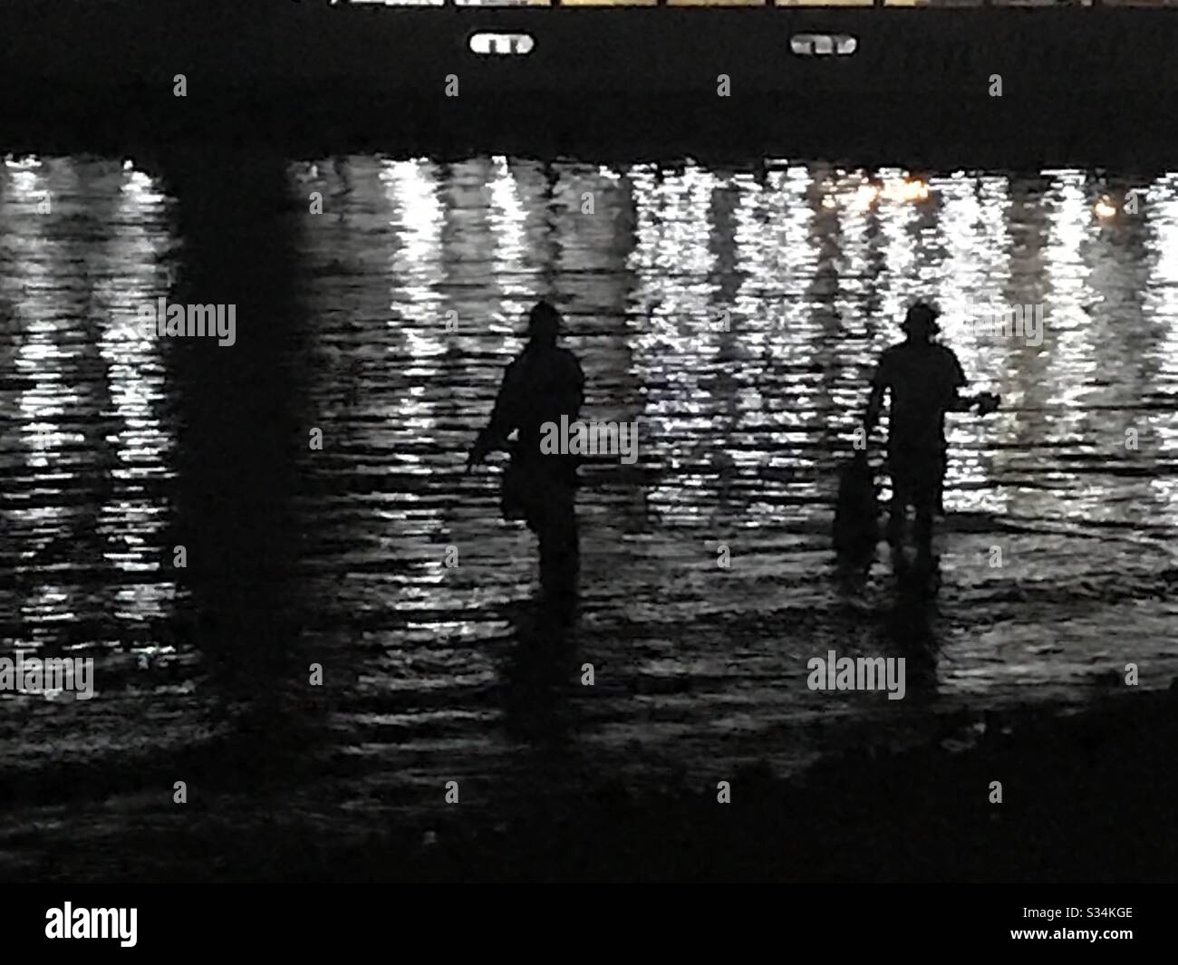 Night fishing: Zanzibar,two men fishing for squids/calamari and octopus at night Stock Photo
