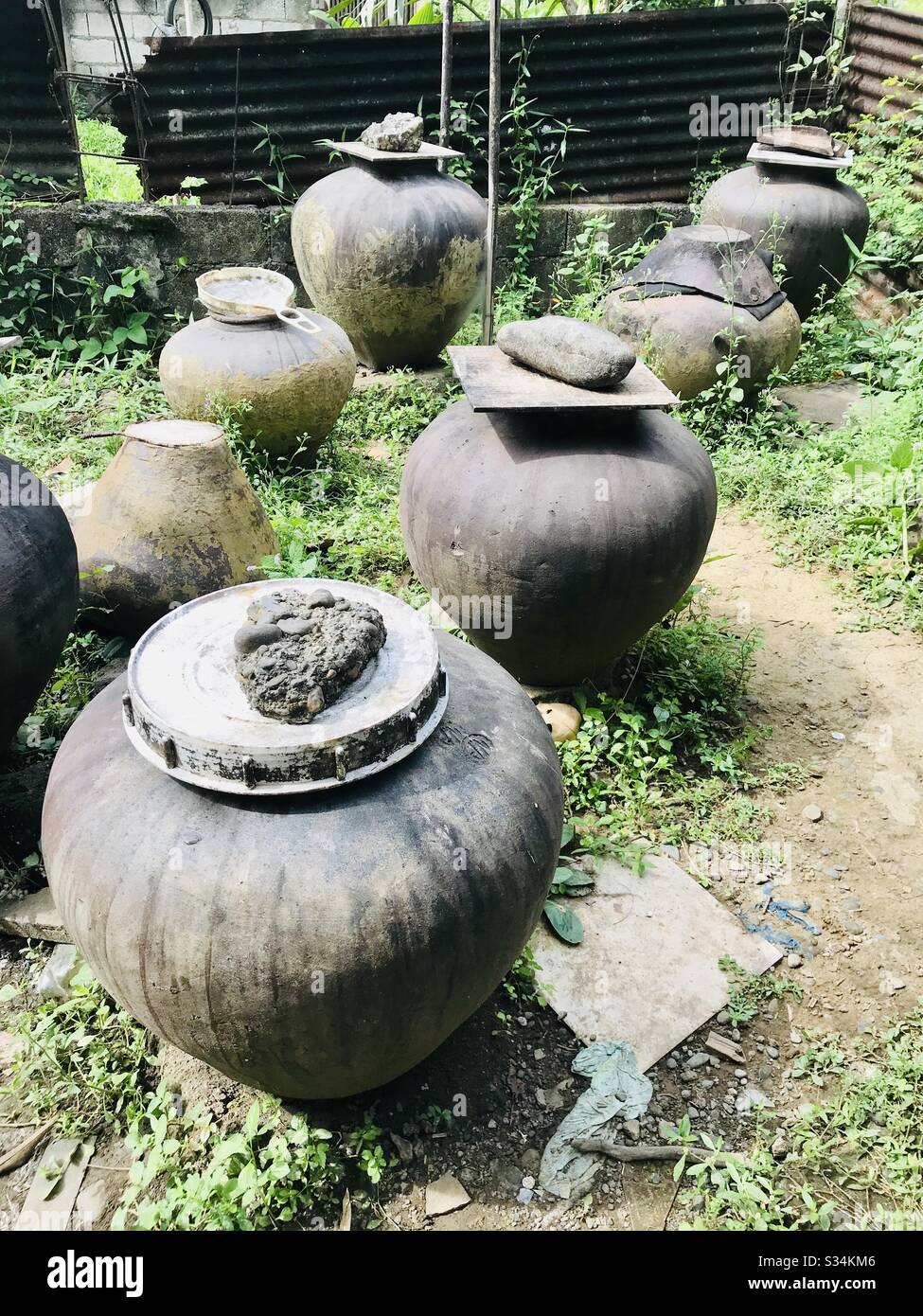 Traditional vinegar fermentation on terracotta pots.  A rare sighting of an heirloom process of making vinegar that will make one appreciate every drop. It has a potent acidity and earthy notes. Stock Photo