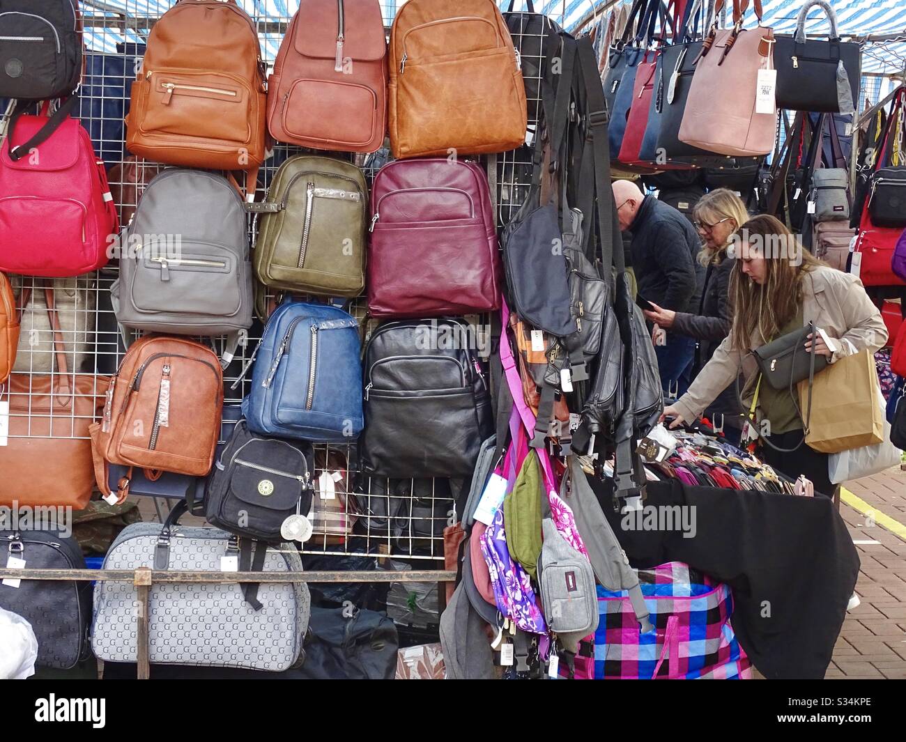 Customers buying bags at a market stall in Leighton Buzzard in England Stock Photo