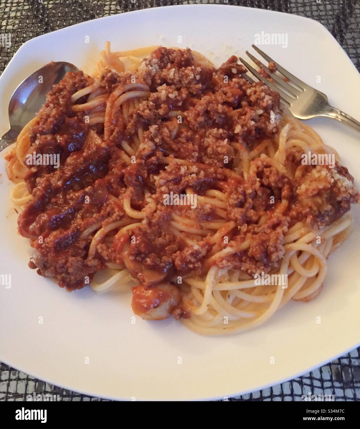 Entrée dish of spaghetti Bolognese on a white plate - Smartphone Captured Stock Image