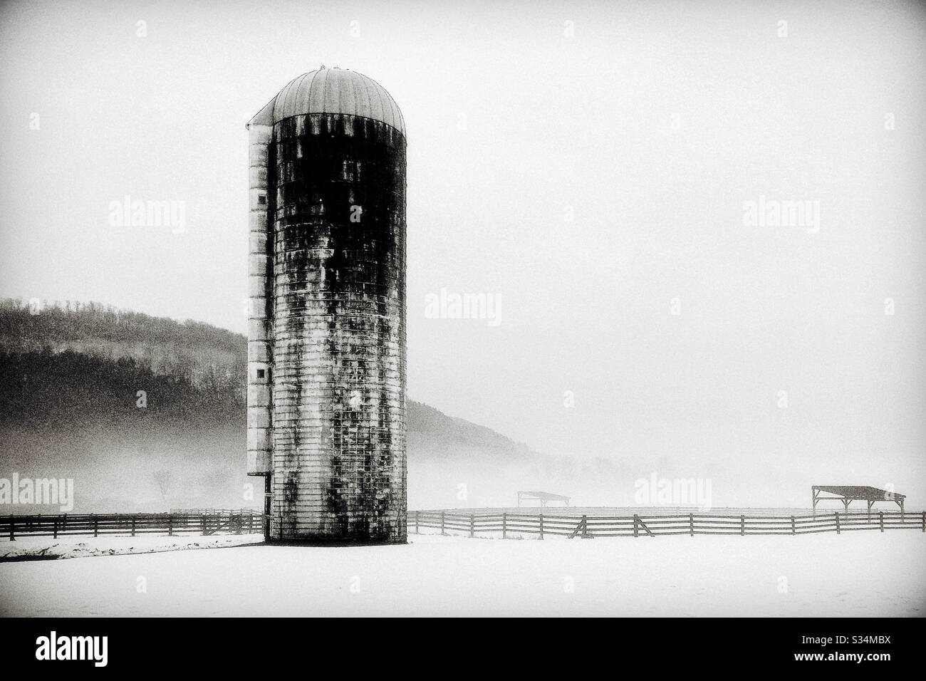 Single Silo on Snow Covered Field at a Farm Stock Photo