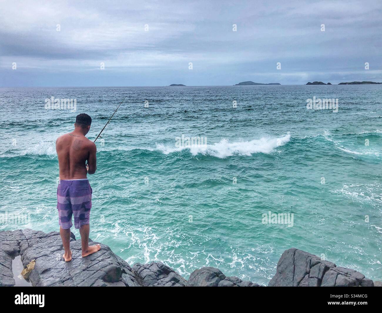 Fishing from the rocks. - Smartphone Captured Stock Image
