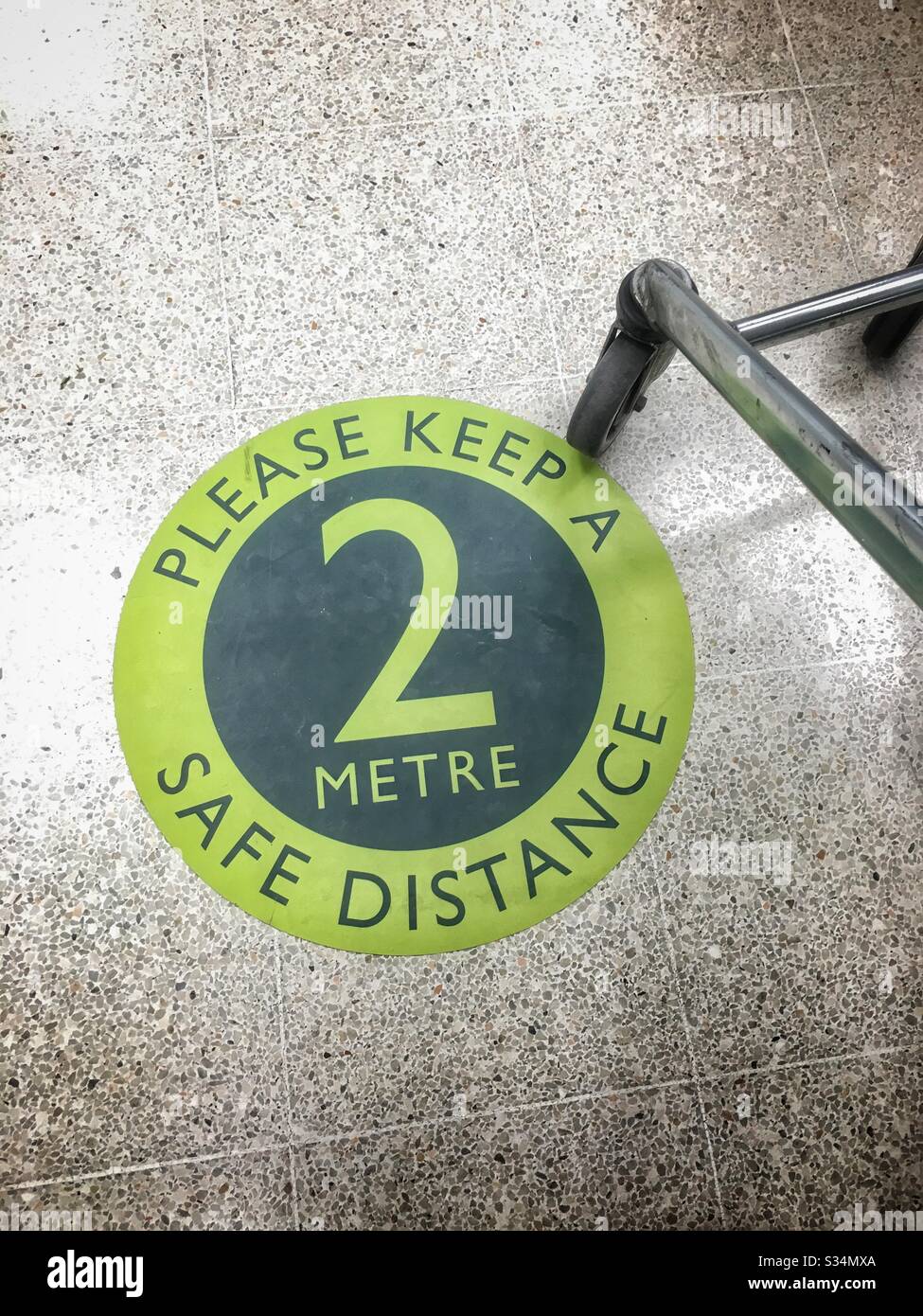 Social distancing; sign on the floor in a Waitrose supermarket UK Stock Photo