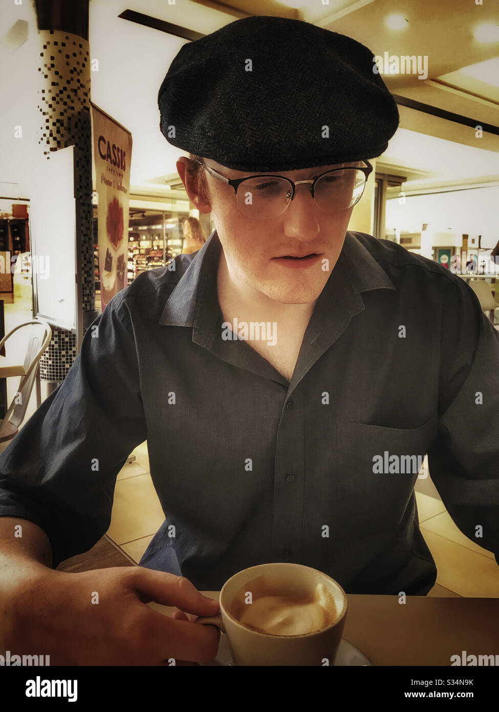 Man drinking a cappuccino. - Smartphone Captured Stock Image