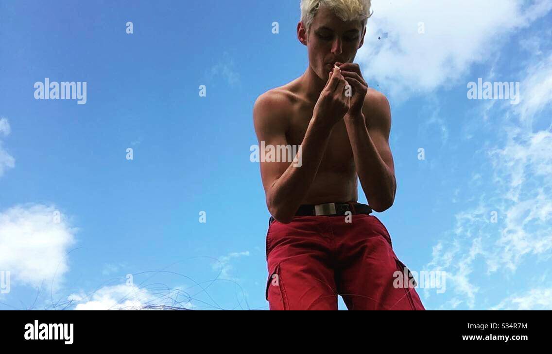 Young teen lighting a cigarette. Stock Photo