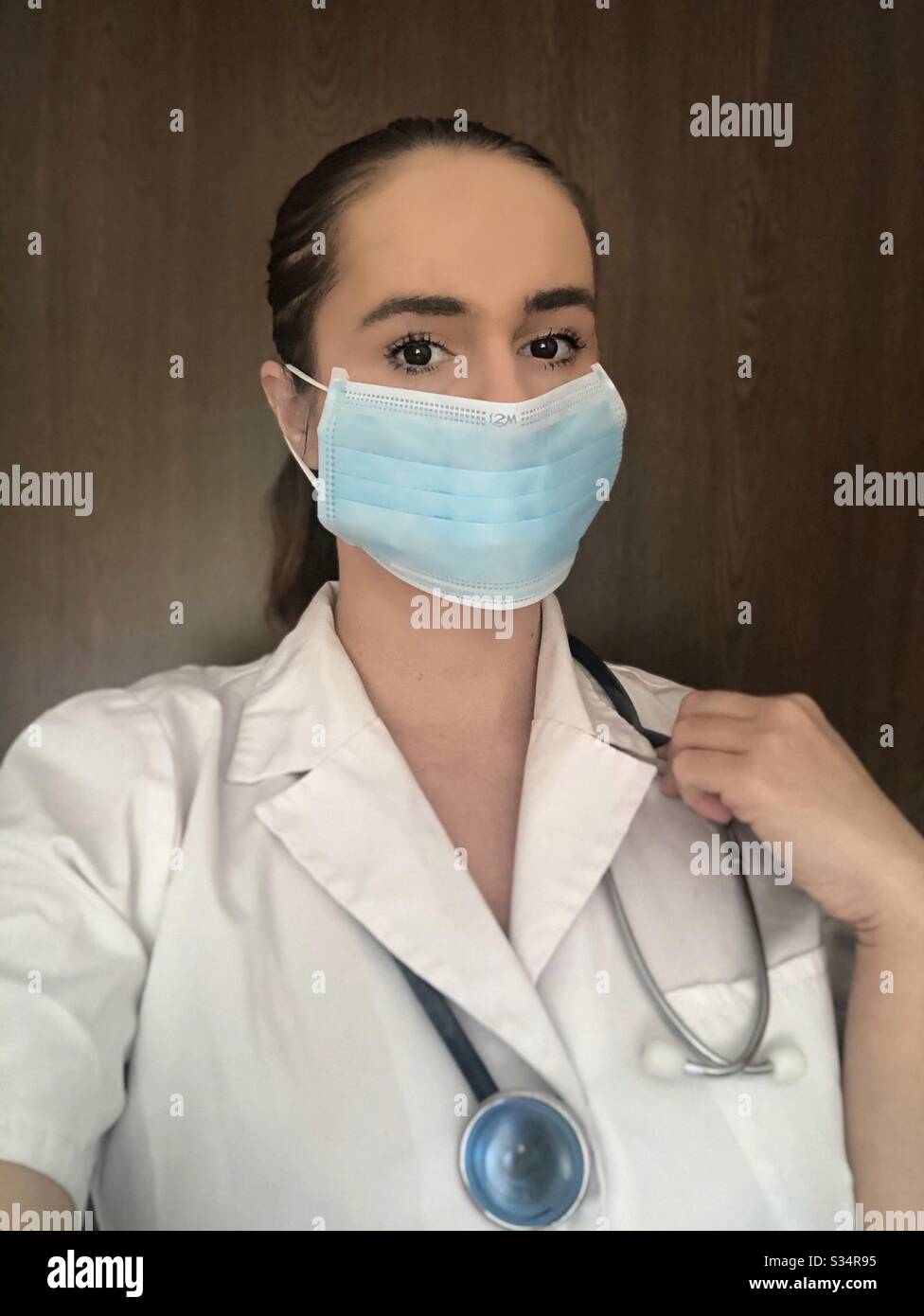 Medical intern wearing mask and stethoscope Stock Photo