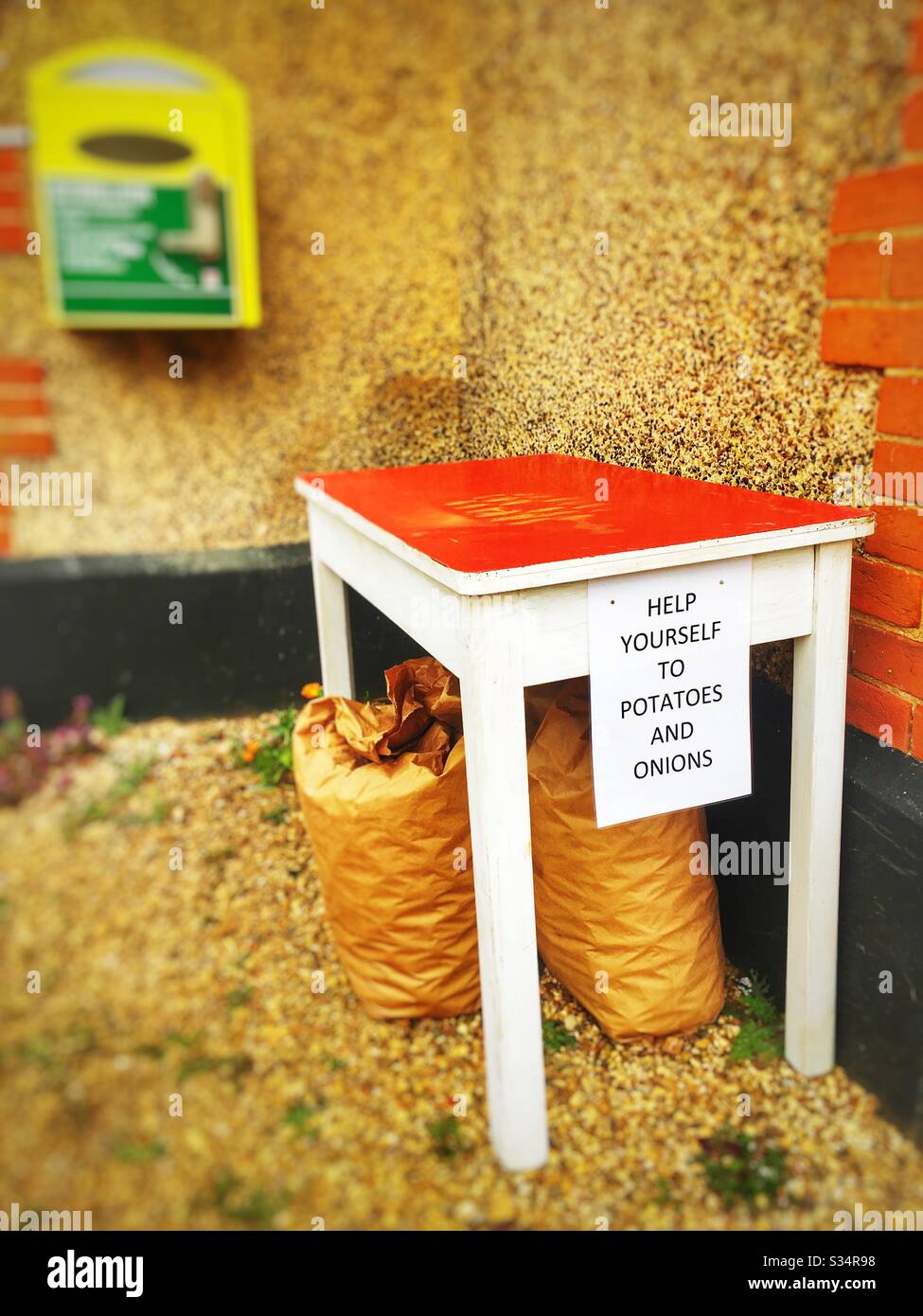 Help yourself to potatoes and onions during the lockdown outside Bawdsey village hall in Suffolk UK - Smartphone Captured Stock Image