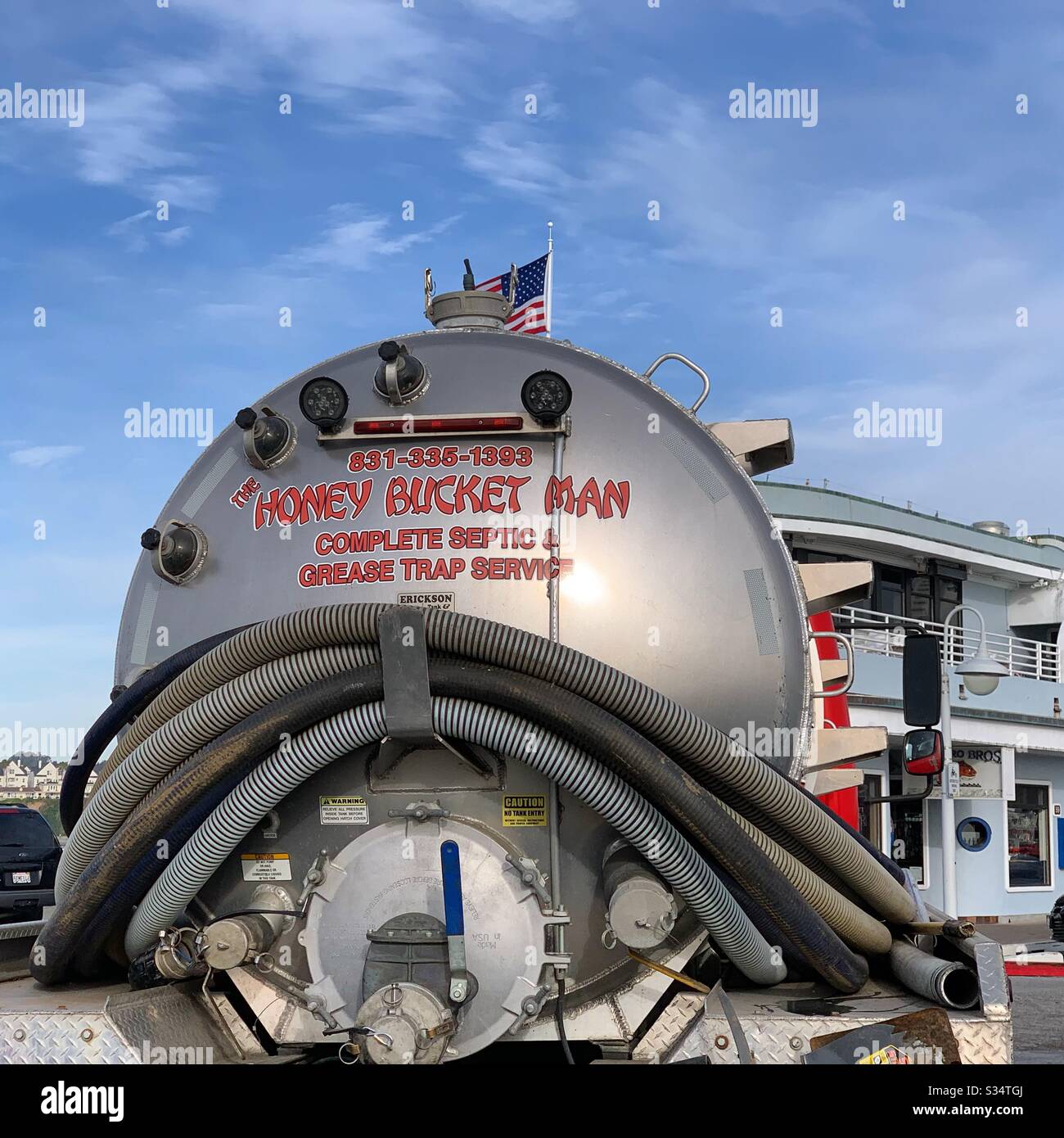“Honey Bucket Man. Complete Septic and Grease Trap Service” truck parked on Santa Cruz Wharf in the morning, Santa Cruz, California, United States - Smartphone Captured Stock Image