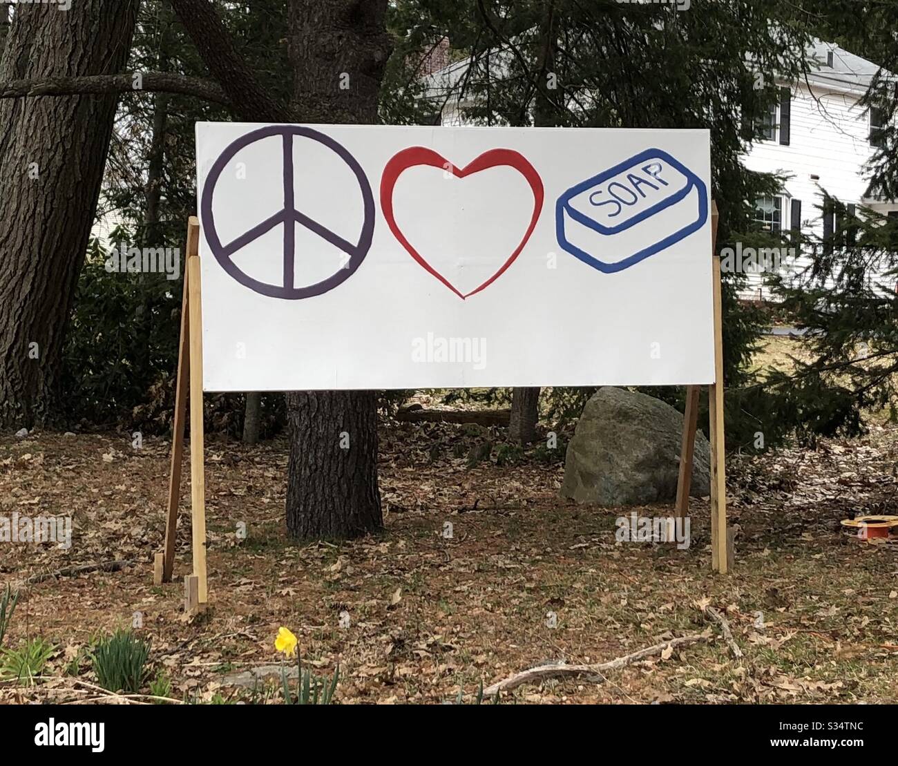 A sign encouraging peace, love, and hand washing in Westford, Massachusetts, USA. Stock Photo