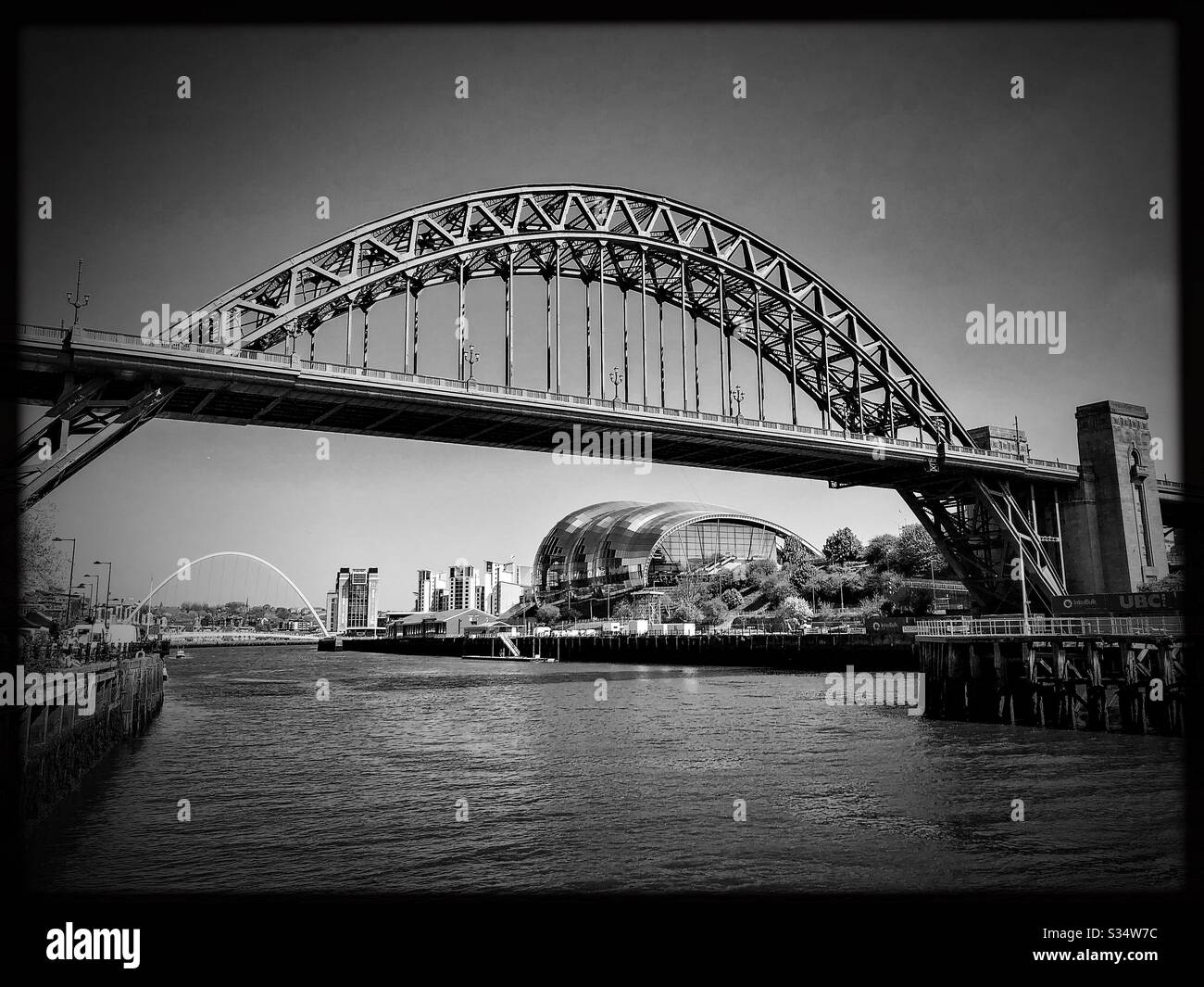 Architecture of Newcastle Quayside. Black and white edit. Newcastle upon Tyne, North East England. The Tyne Bridge, Sage Gateshead and Millennium Bridge by the River Tyne. - Smartphone Captured Stock Image