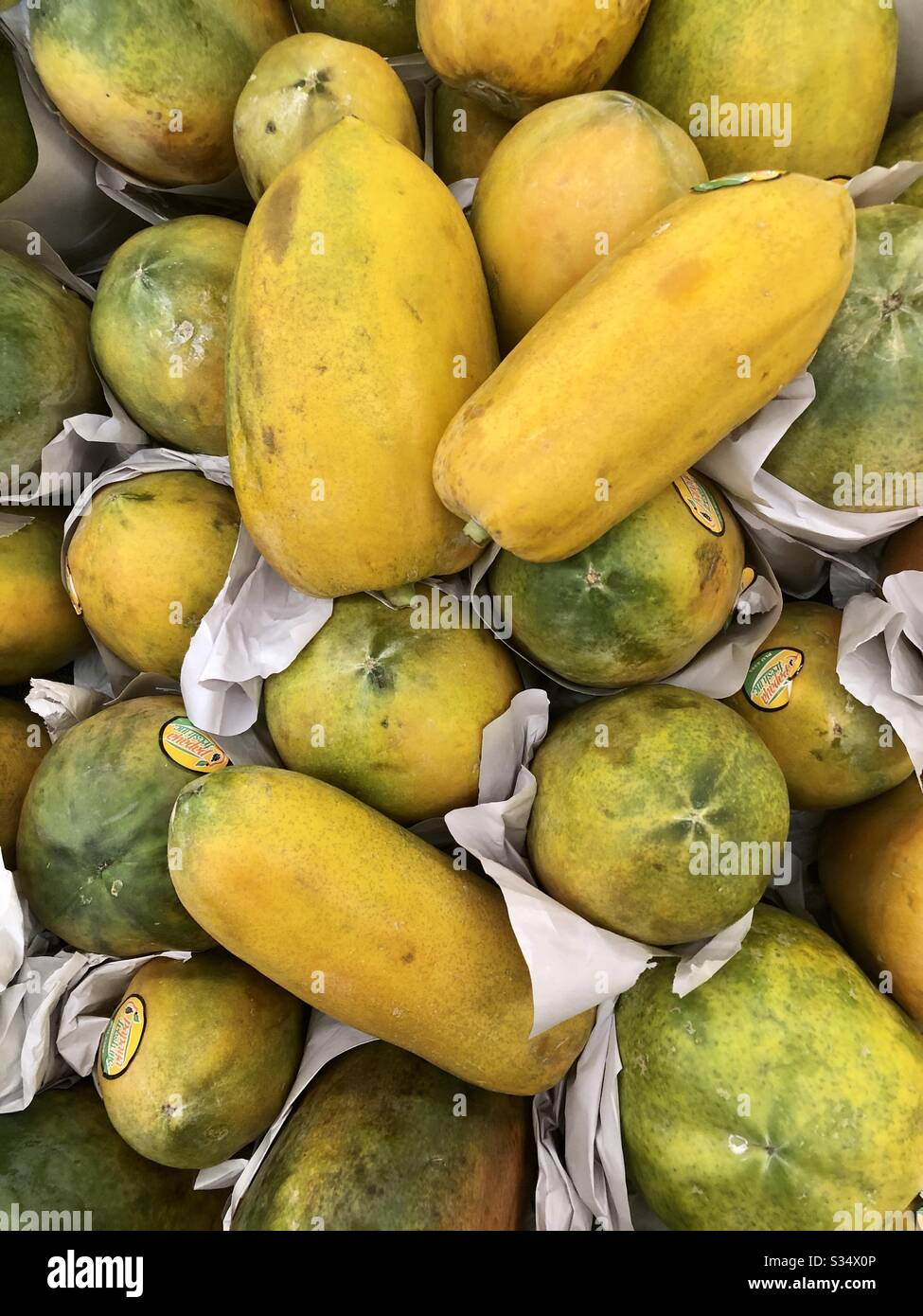 Papayas, fruit, food, store grouping, yellow as ripening, sold by the pound, tasty, nutritional, various ways to enjoy, closeup Stock Photo