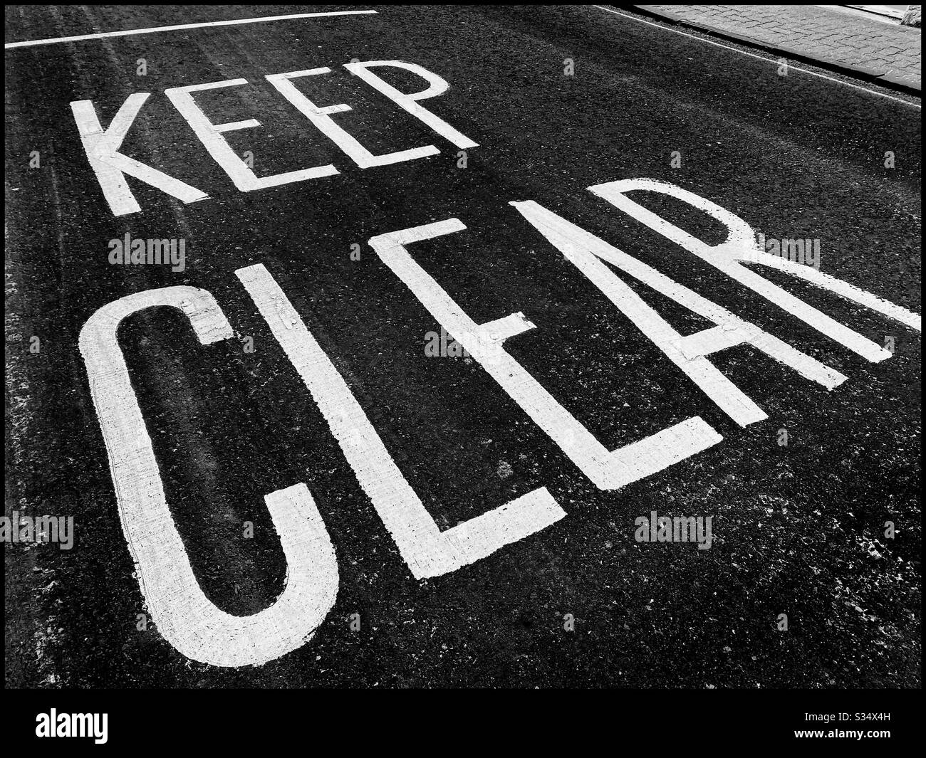 KEEP CLEAR road markings - an instruction to motorists to not park or leave their vehicles in this area. Photo Credit - © COLIN HOSKINS. - Smartphone Captured Stock Image