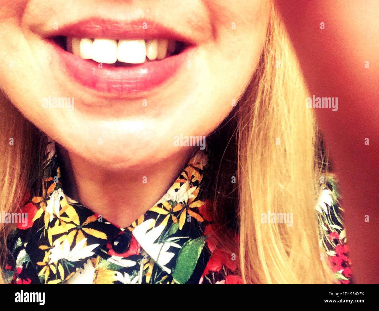 Self isolation staying happy and smiling. Quarantine at home selfie. Close up of smiling face - Smartphone Captured Stock Image