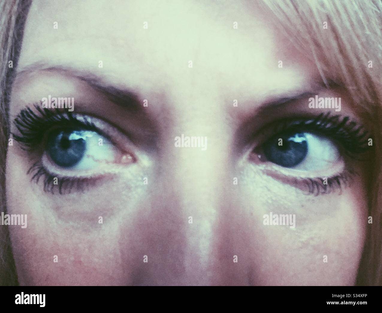 Self isolation quarantine, close up of eyes. Lonely and scared. Coronavirus lockdown - Smartphone Captured Stock Image