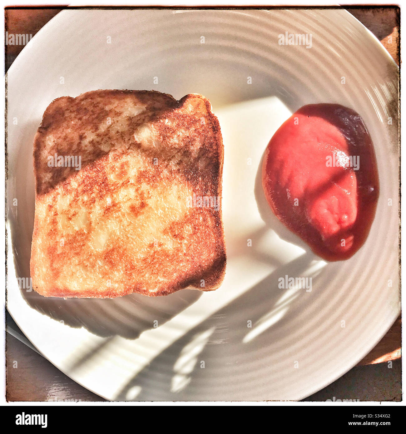 Toasted cheese with tomato sauce on white plate Stock Photo Alamy