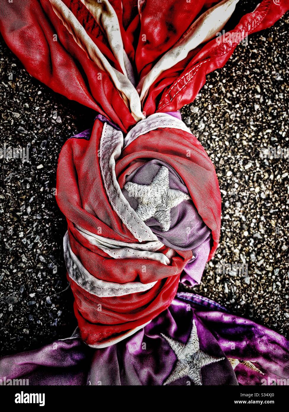 American flag tied in knot in parking lot - Smartphone Captured Stock Image