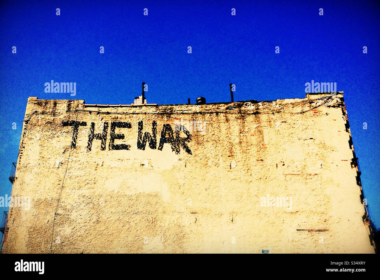 The War Graffiti on the Side of a Brick Wall Stock Photo