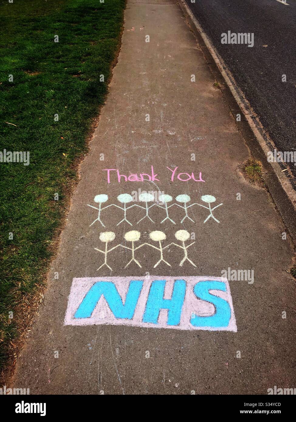 Coronavirus 2020 lockdown - public message of support chalked on British pavement sidewalk UK 'Thank you NHS' Stock Photo