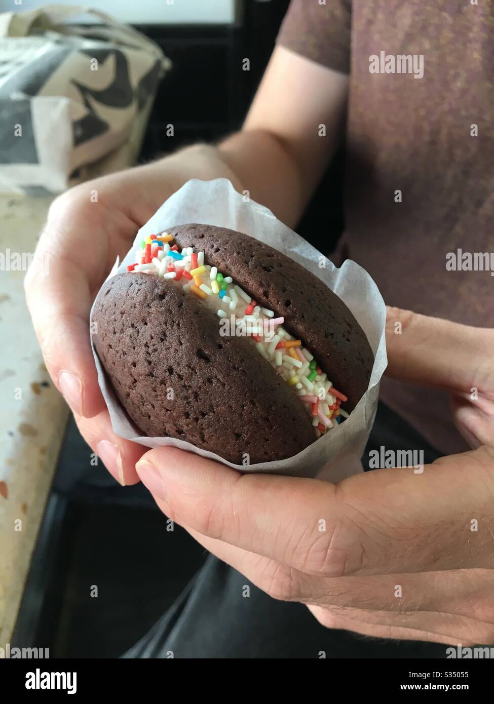 Young Man Holding A Whoopie Pie With Sprinkles Stock Photo Alamy