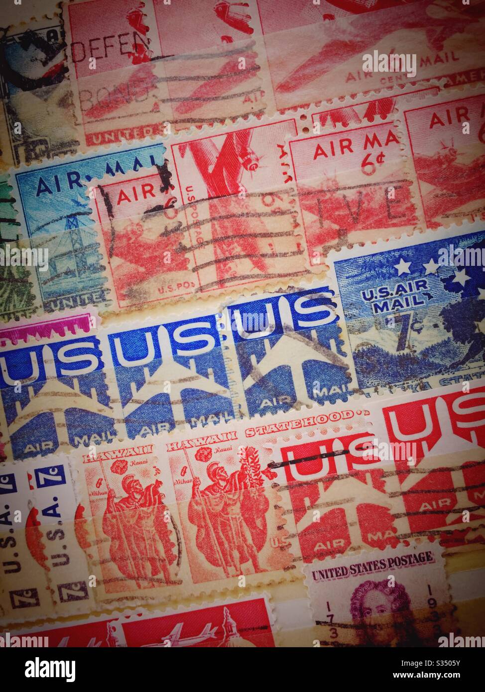 Vintage used air mail stamps filed in a stamp collectors stock book, USA - Smartphone Captured Stock Image