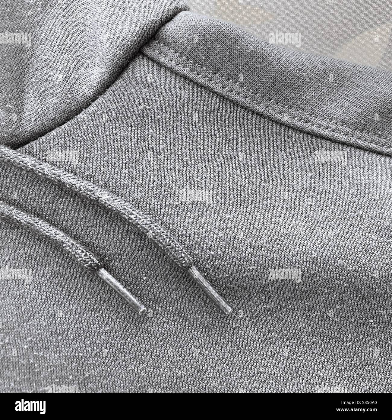 Close up details of designer men’s clothes, menswear. hooded jumper, hoodie, hoody. - Smartphone Captured Stock Image