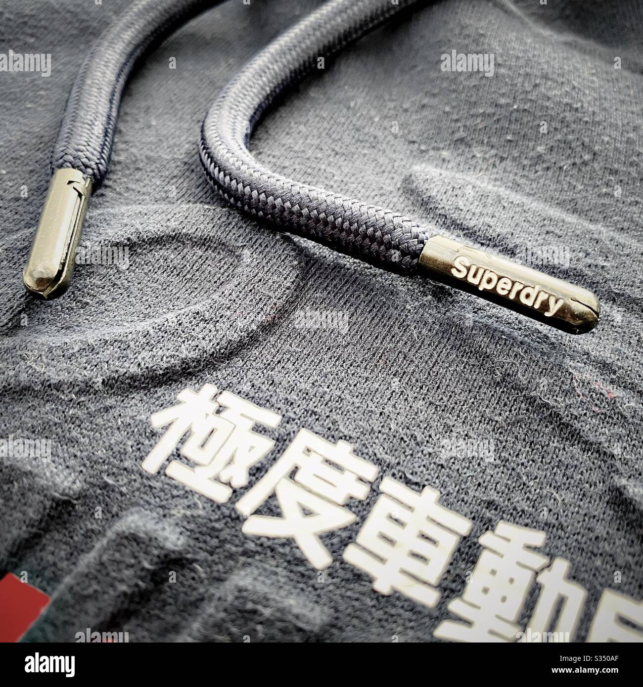 Close up details of designer men's clothes, menswear. Superdry hooded  jumper, hoodie, hoody. Logo and branding Stock Photo - Alamy