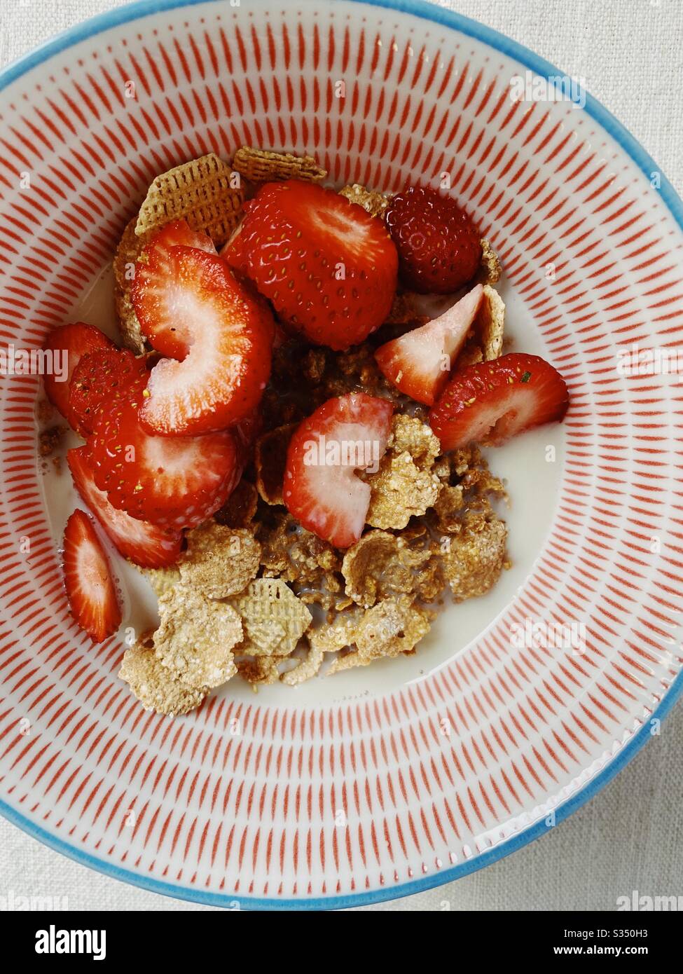 Healthy grain cereal with strawberries and oat milk - Smartphone Captured Stock Image