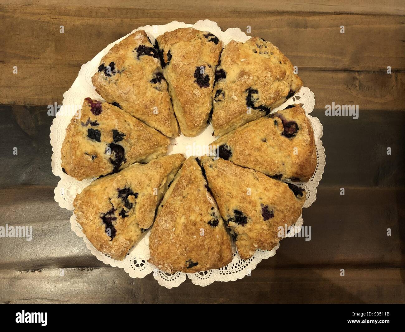 Photo of home made blueberry scones taken from above and divided into eight triangles. Stock Photo